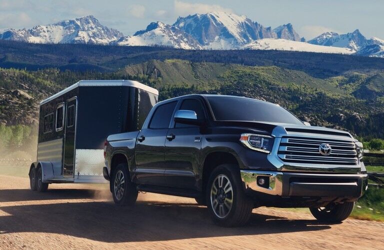 Front passenger angle of a black 2020 Toyota Tundra towing a trailer