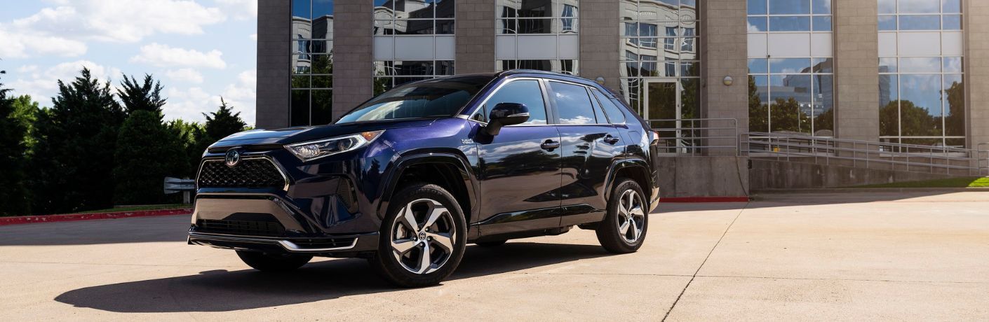 2023 Toyota RAV4 Prime parked in front of a building.