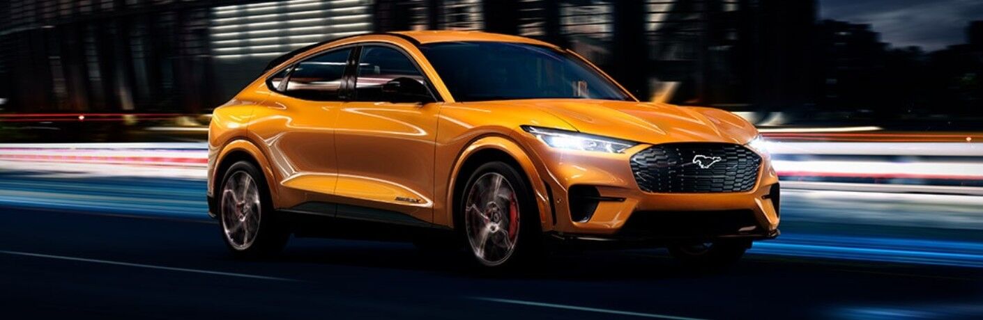 Front passenger angle of an orange 2021 Ford Mustang Mach-E