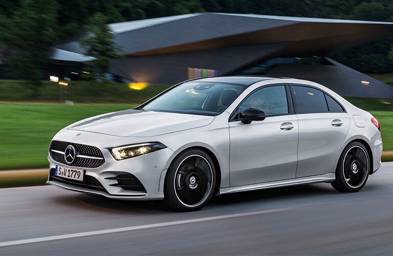 white mercedes-benz a-class sedan driving through a neighborhood
