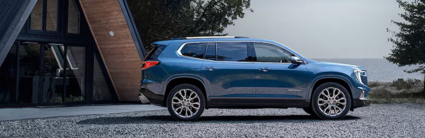 2026 GMC Acadia side view on rocks