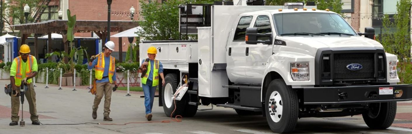 2025 Ford Medium Duty on a work site with three workers