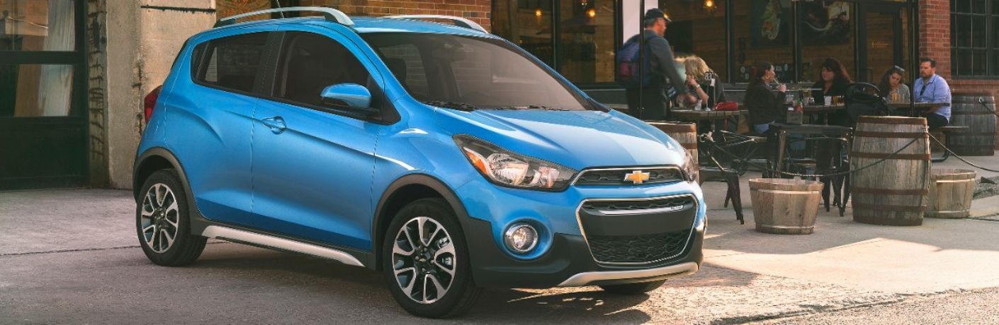 2017 Chevrolet Spark parked near a restaurant