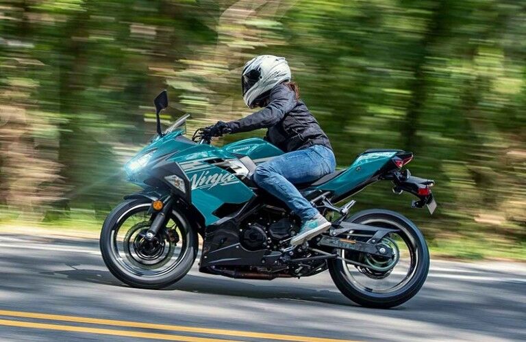 Person riding a blue 2021 Kawasaki Ninja 400