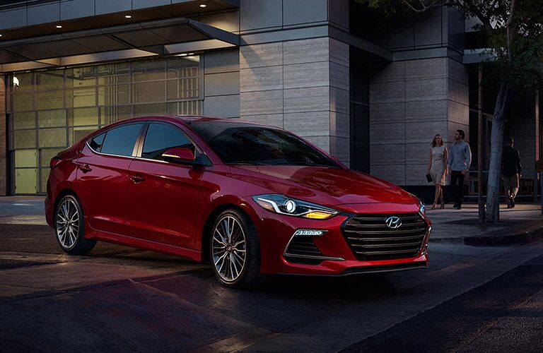 red 2018 Hyundai Elentra in front a building