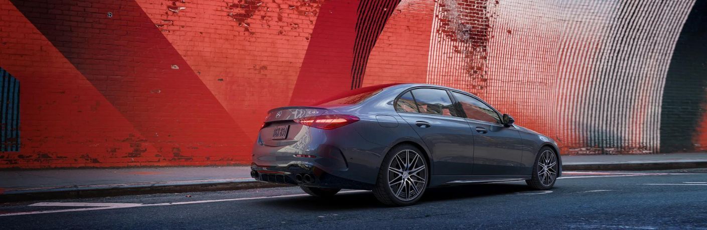 side view of the 2024 Mercedes-Benz AMG C 43 4MATIC Sedan on a road
