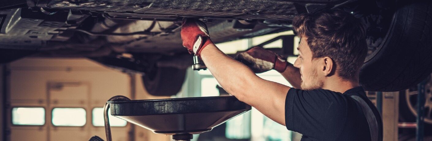 Mechanic changing the oil in a car