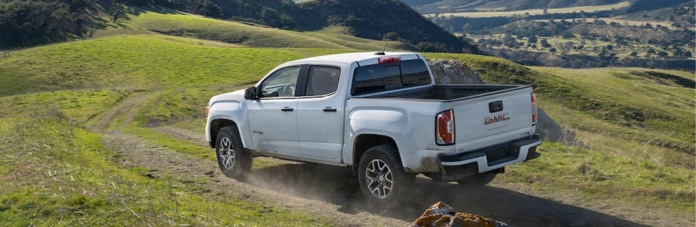 GMC truck in an off-road trail in a hilly area