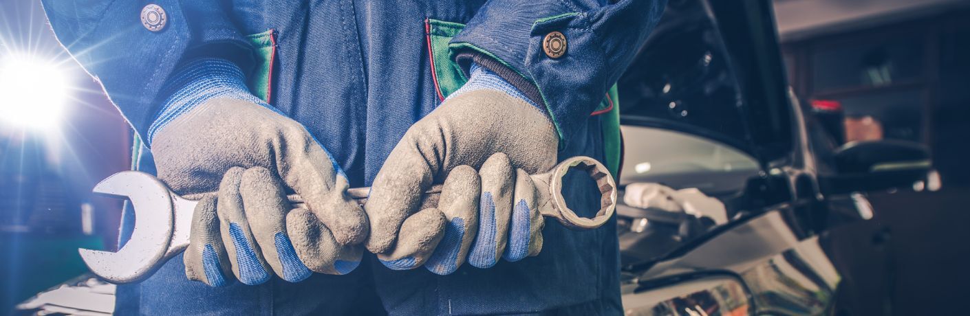 a mechanic holding a wrench