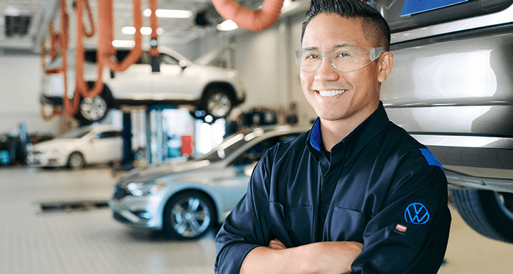 Volkswagen Mechanic looking under car