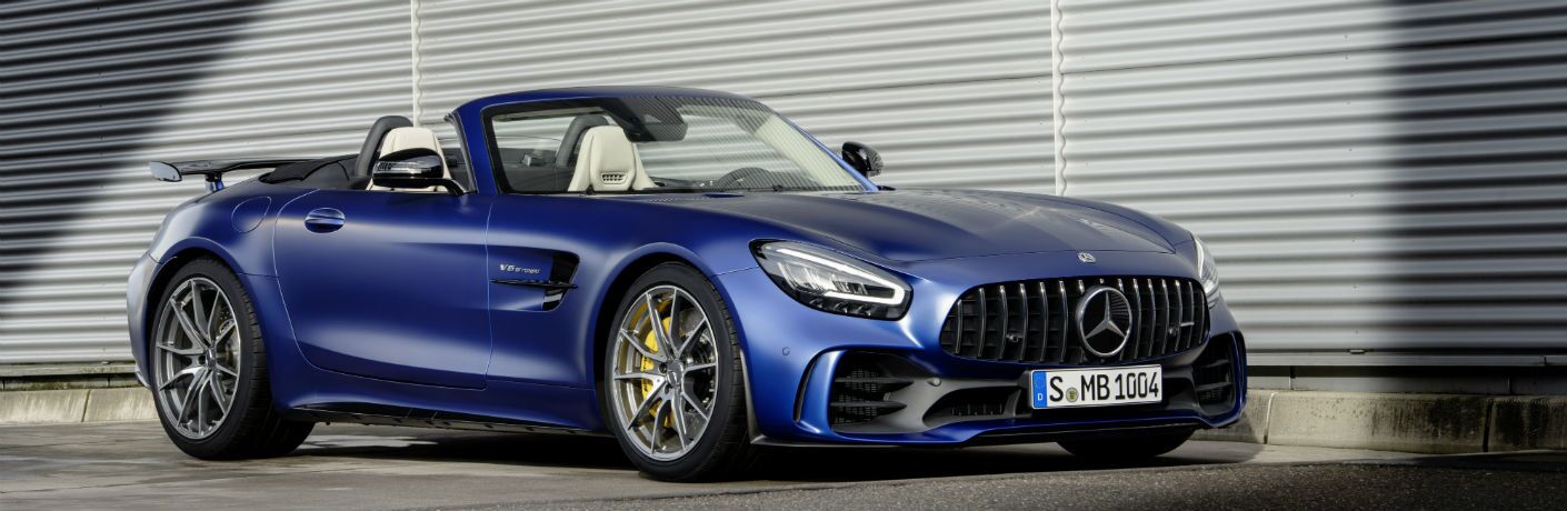 2020 MB AMG GT R Roadster exterior front fascia and passenger side in front of closed garage door