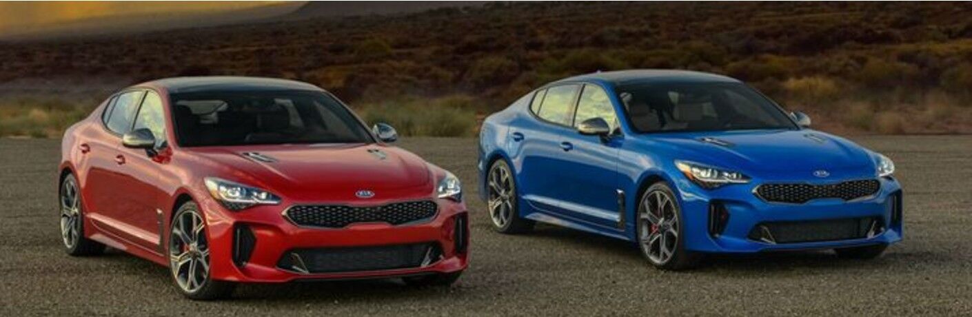 Two 2021 Kia Stinger vehicles parked side-by-side outside