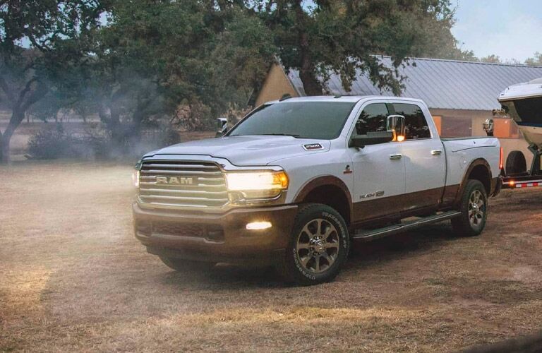 Front view of the 2021 Ram 2500 with headlights on during the evening