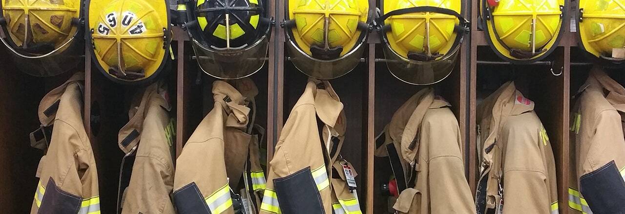 firemans' lockers with uniforms hanging