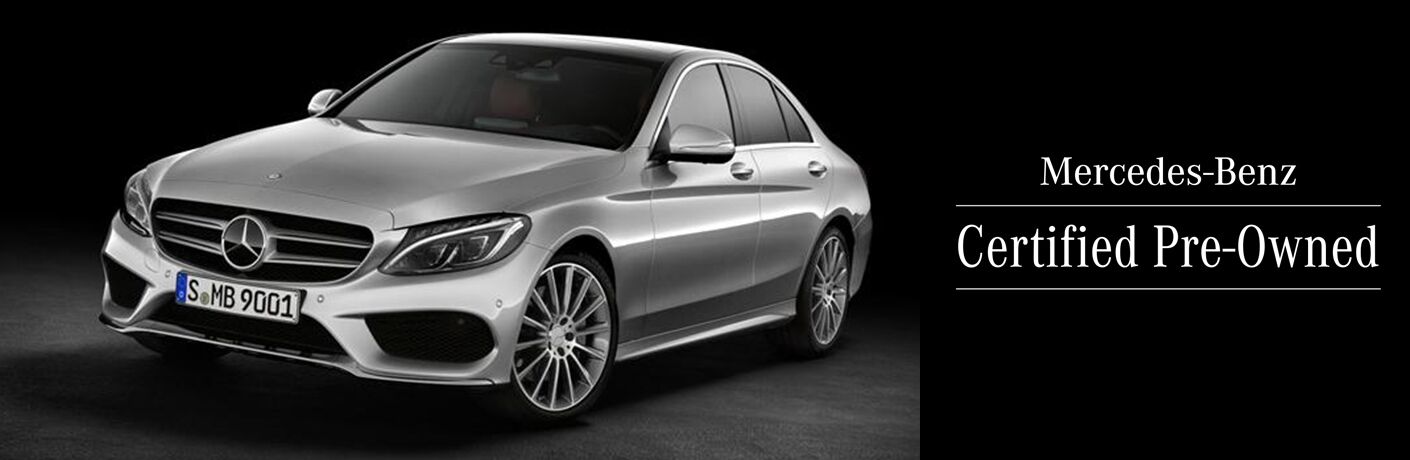 MB CPO sedan exterior front fascia and driver side in black background
