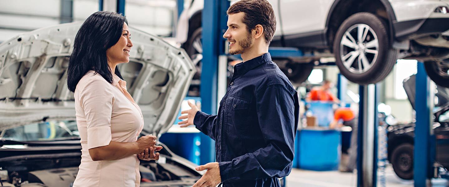 service technician talking to customer in service department