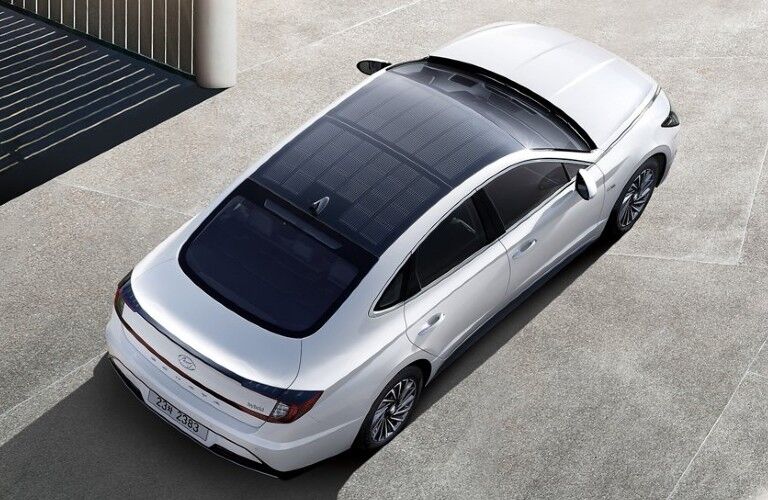 Rear aerial view of a white 2021 Hyundai Sonata Hybrid