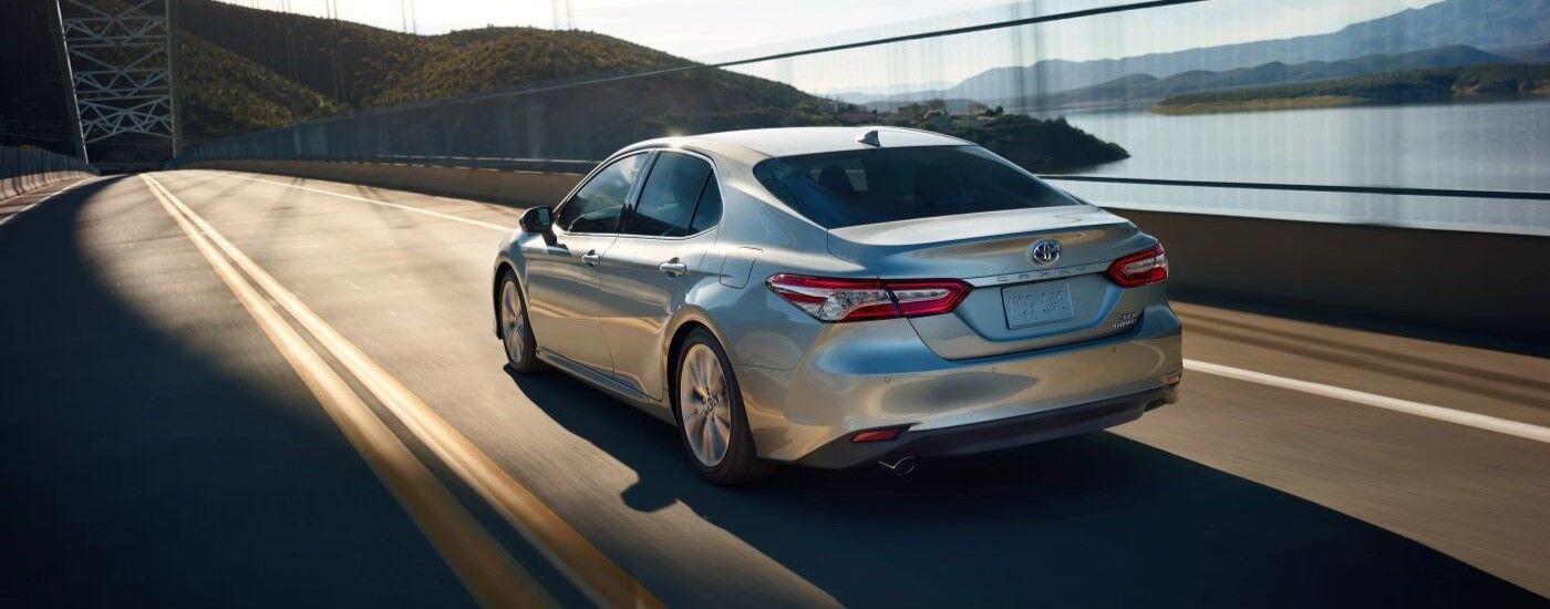 Silver 2020 Toyota Camry driving over a bridge