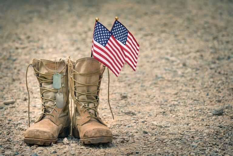 Combat boots with American flags and dog tags