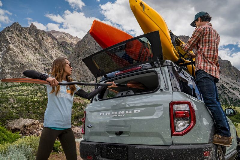 People loading gear into and onto the 2024 Ford Bronco Sport.