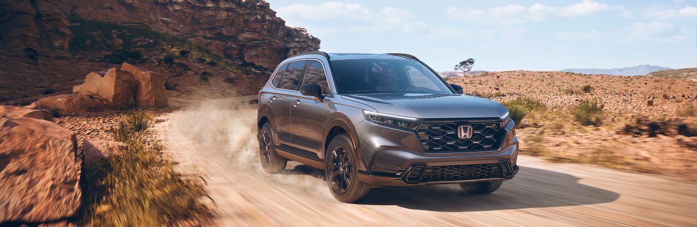 A 2023 Honda CR-V speeding on a gritty terrain