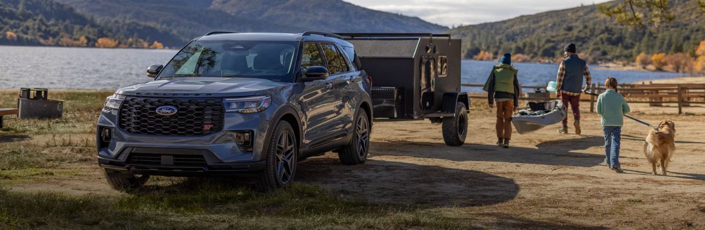 2026 Ford Explorer towing a trailer by a lake