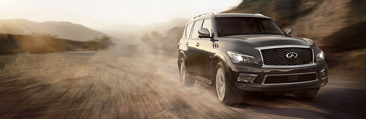 2017 INFINITI QX80 driving on dirt road