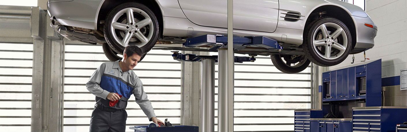 MB maintenance car raised technician grabbing from tool box