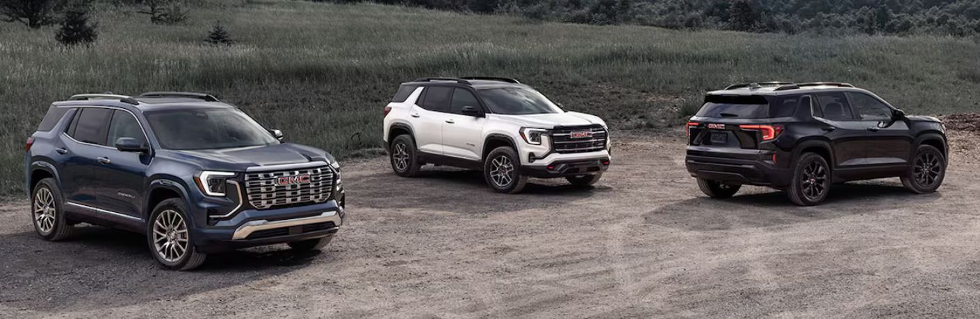 2026 GMC Terrain models parked in a dirt parking lot
