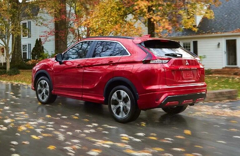 2022 Mitsubishi Eclipse Cross red driving by houses