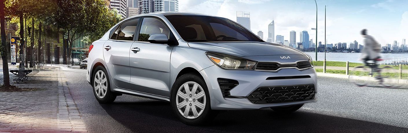 2023 Kia Rio Parked In Front of a Large City