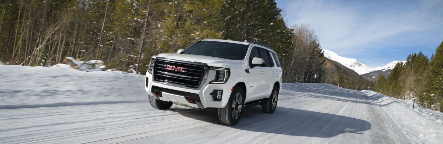 2021 GMC Yukon AT4 going down the road in the snow