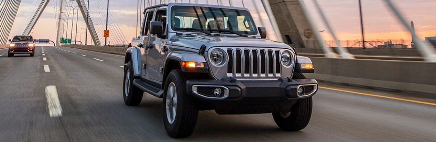 A man driving the 2021 Jeep Wrangler on top of a bridge
