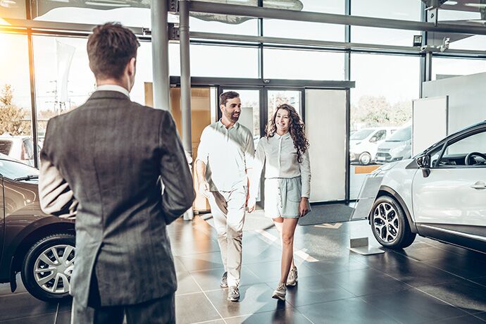Salesman greeting couple