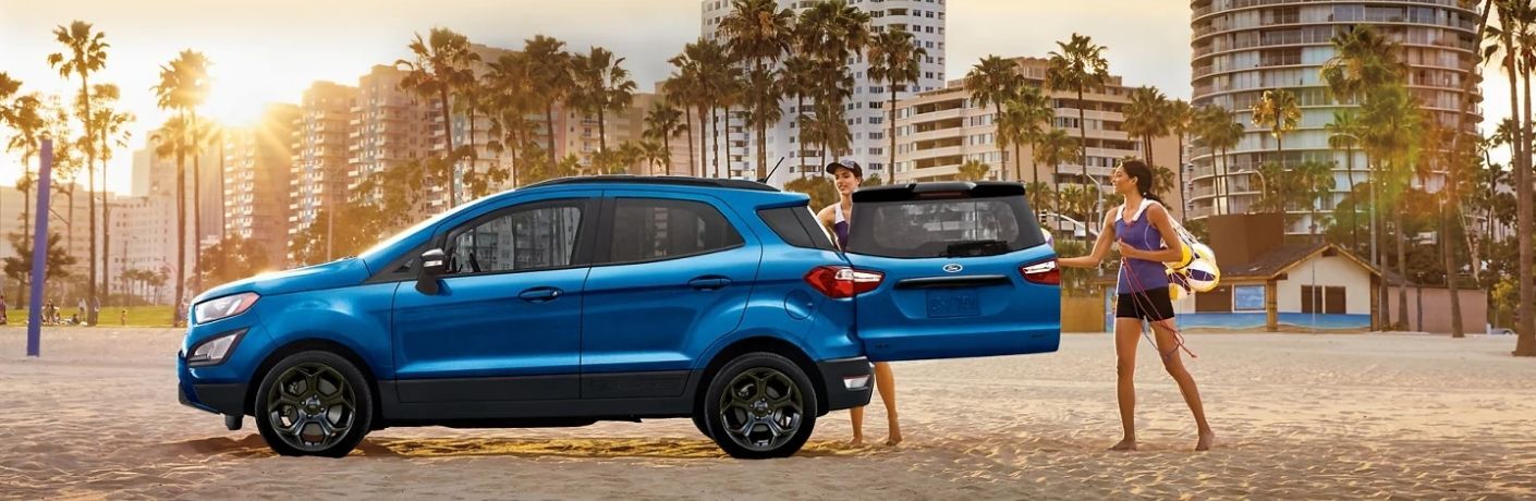 Two women loading the 2022 Ford EcoSport's cargo on a beach