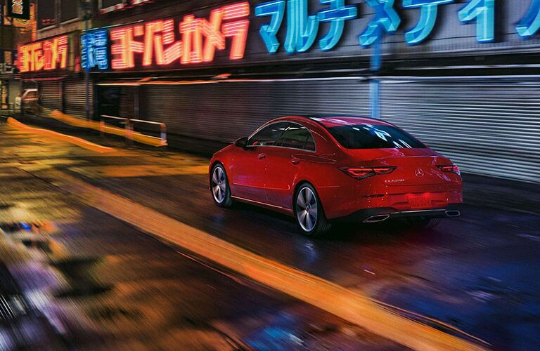 2020 MB CLA Coupe exterior rear fascia driver side in city at night with neon lights