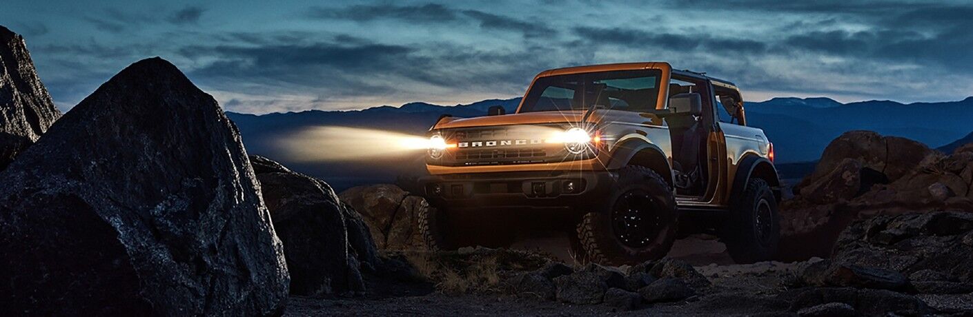 Ford Bronco parked off-road at night