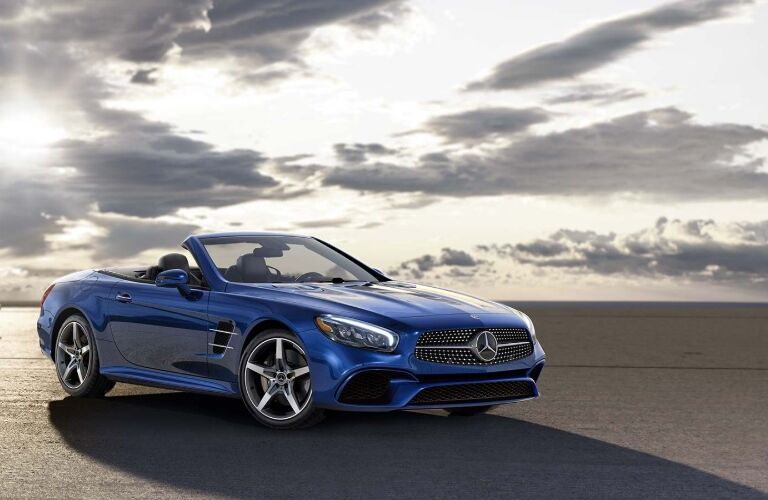 blue mercedes-benz sl roadster at sunset