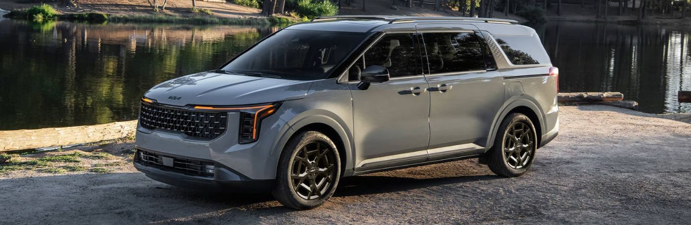 2026 Kia Carnival Hybrid model side and front angle