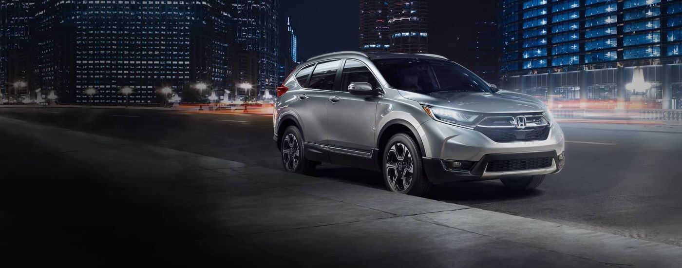 Silver 2017 Honda CR-V Touring parked on the side of a city street