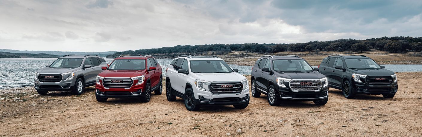 Five 2024 GMC Terrain SUVs parked near lake