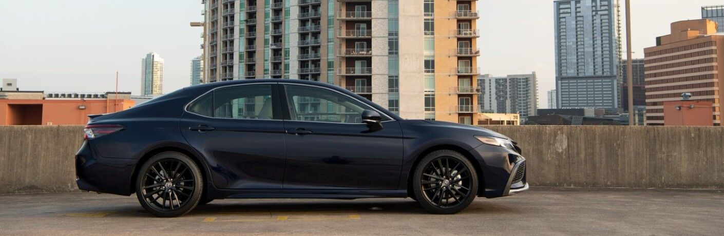2021 Toyota Camry blue parked on top of roof with skyline