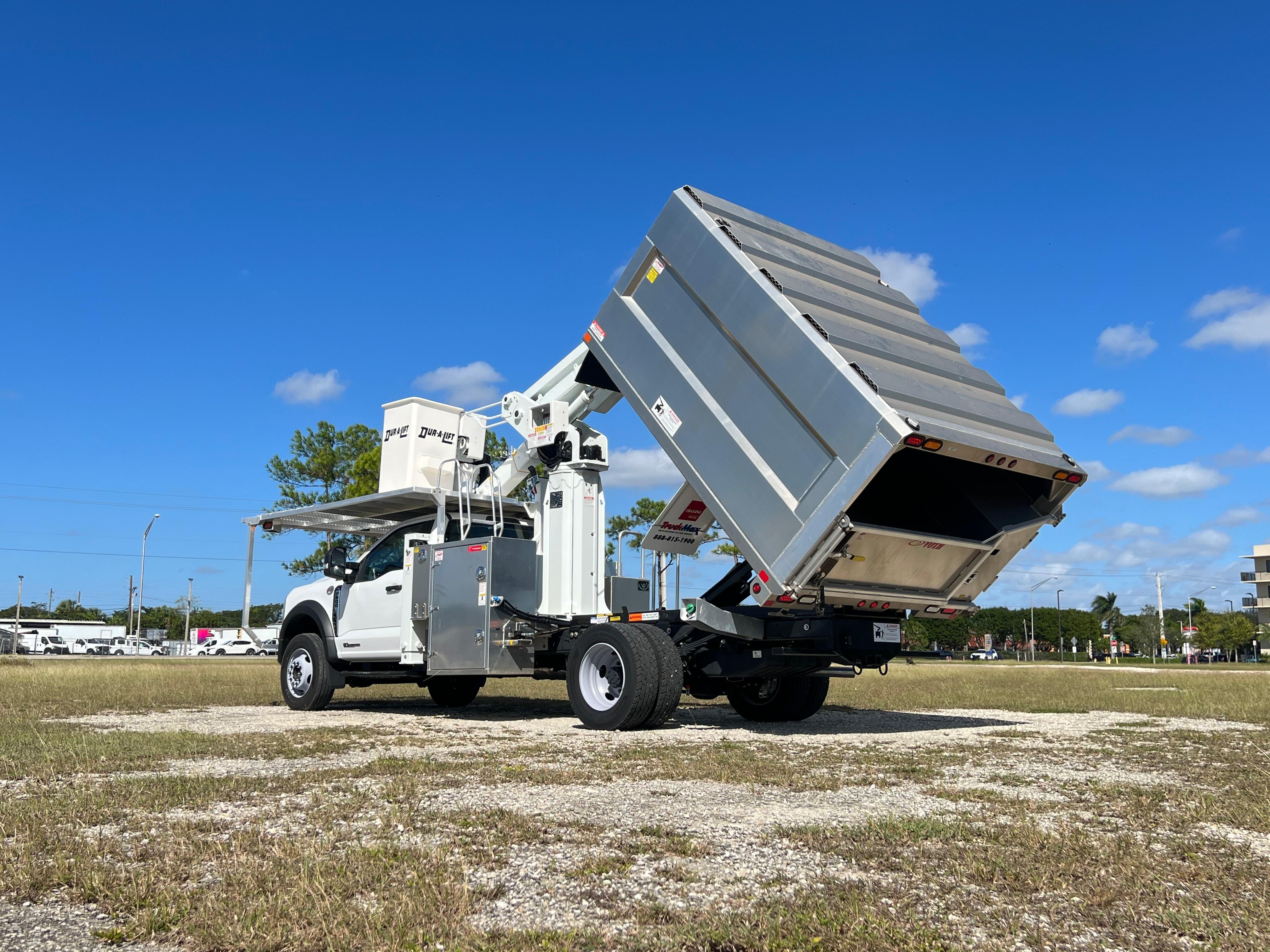 A rear quarter exterior view of a bucket truck using its extendable arm