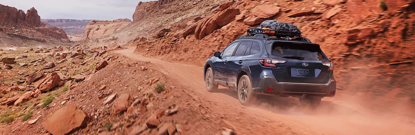 Subaru SUV on a sandy, hilly terrain