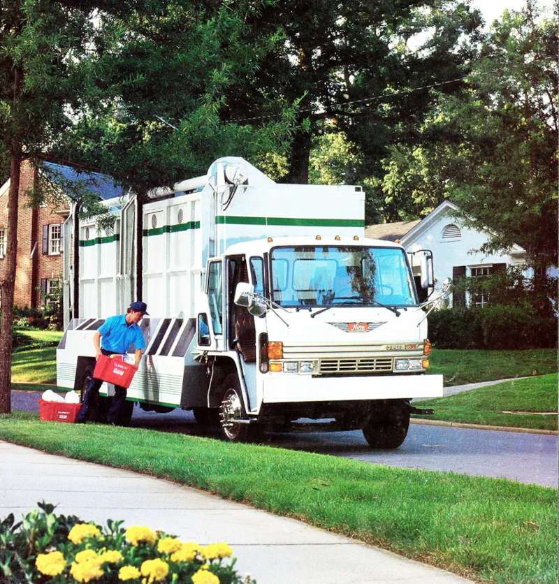 A front quarter exterior view of a Hino garbage truck