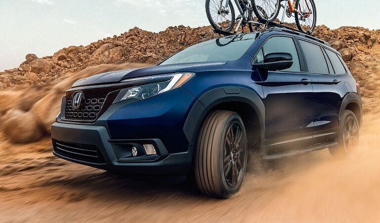 blue Honda Passport with bikes