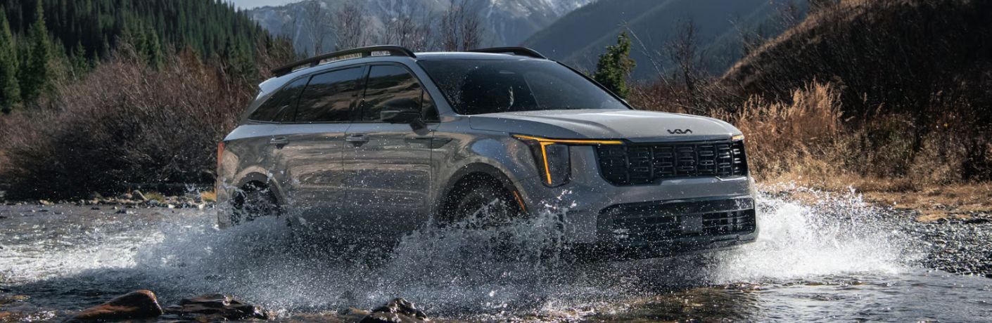 front and side view of the 2026 Kia Sorento off-roading in water