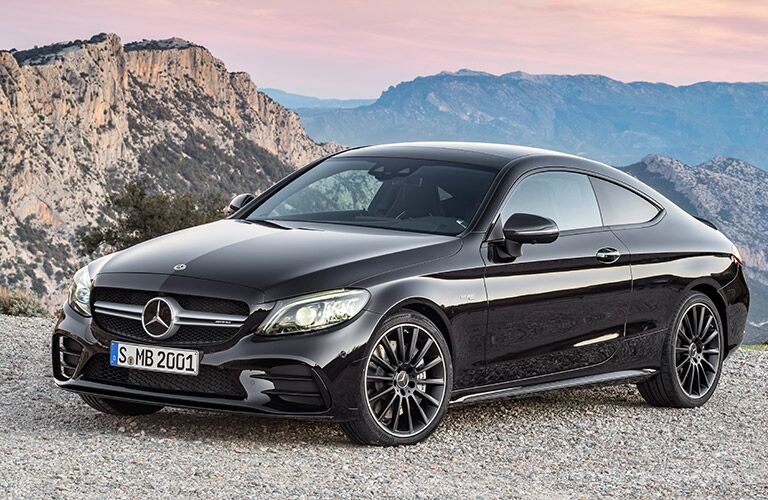 black mercedes-benz c-class coupe with mountains in the background