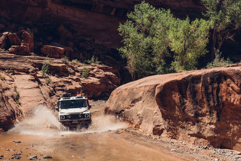 Grenadier splashing through a canyon water crossing at Poison Springs Utah