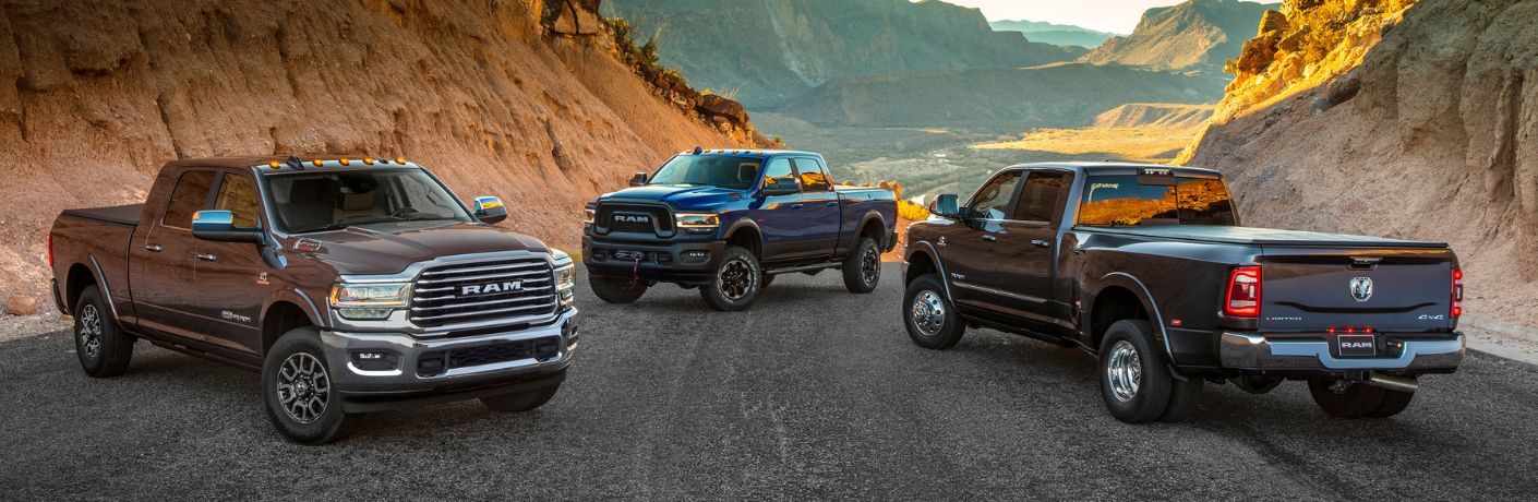 three used Ram trucks parked in a country side road